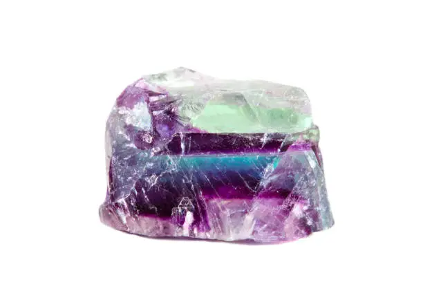 Macro shooting of natural gemstone. Raw mineral fluorite, Brazil. Isolated object on a white background