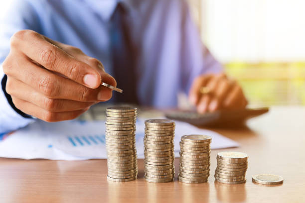 istock Close up,Hand putting money coins stack in saving money and growing business concept. 937704536
