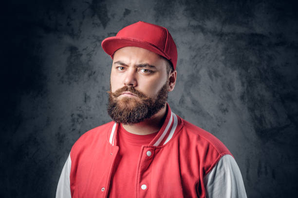 istock A man in hip hop clothes on a grey background. 937707474