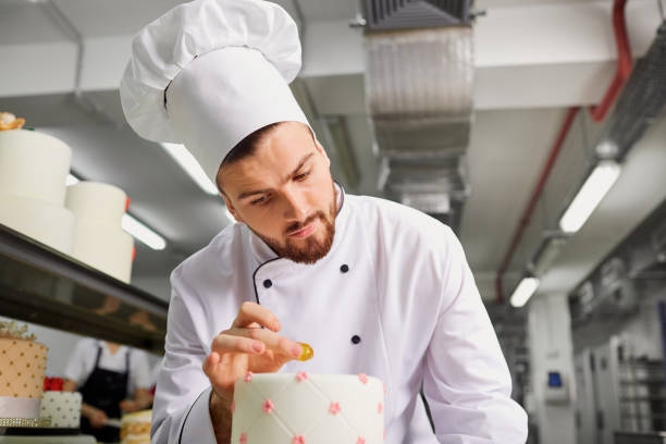 istock Confectioner with a cake in the bakery 937712268