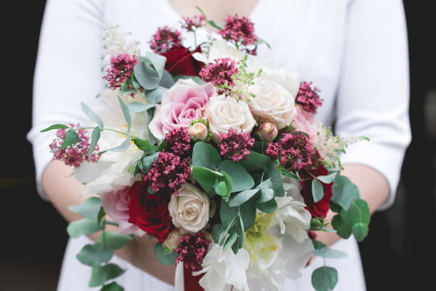istock Bride  holding in hands bouquet of flowers 937714480