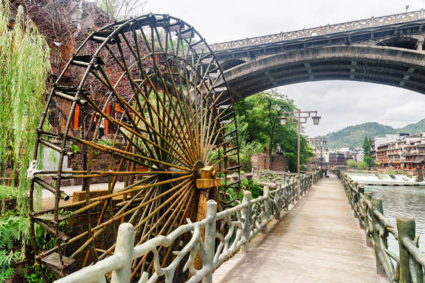 istock Scenic water wheel and bridge in Phoenix Ancient Town, China 937715678