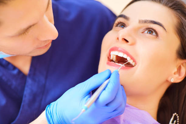 istock The dentist man are treating teeth to  client in dental offic 937715744