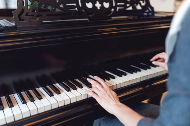 istock Black piano with hands of pianist 937723982