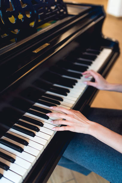 istock Black piano with hands of pianist 937723984