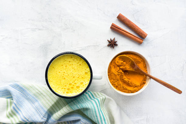 istock Turmeric latte, Cooking Golden Milk On Kitchen. 937728698