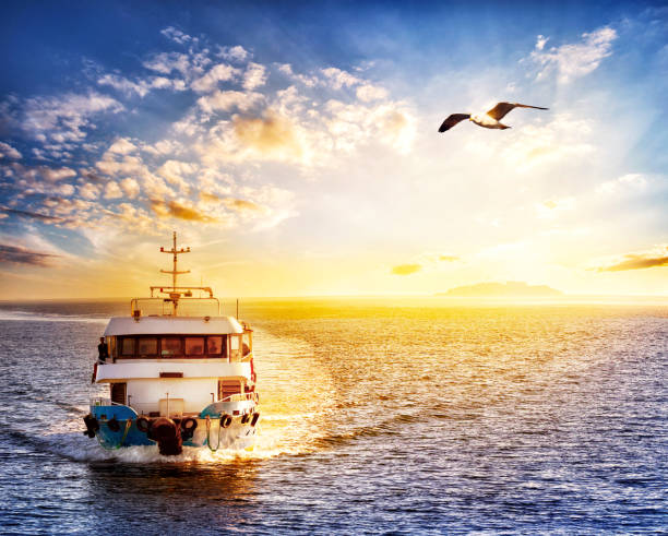 istock Ship at sea with an island 937731312