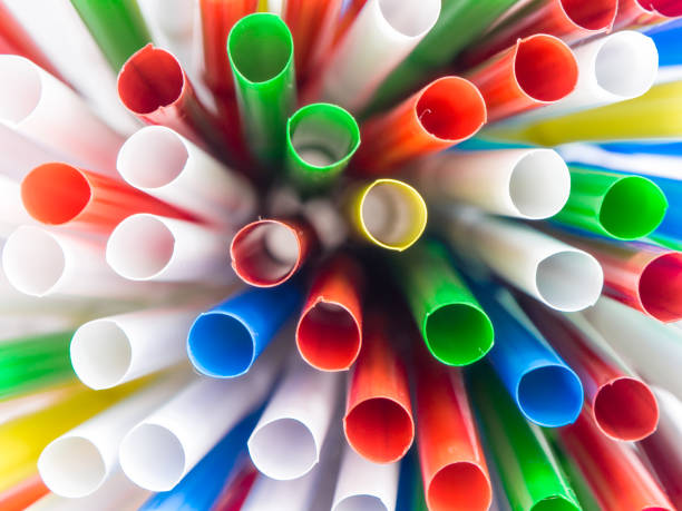 istock Colorful plastic drinking straws over white background. Carrying a summer mood. 937731482