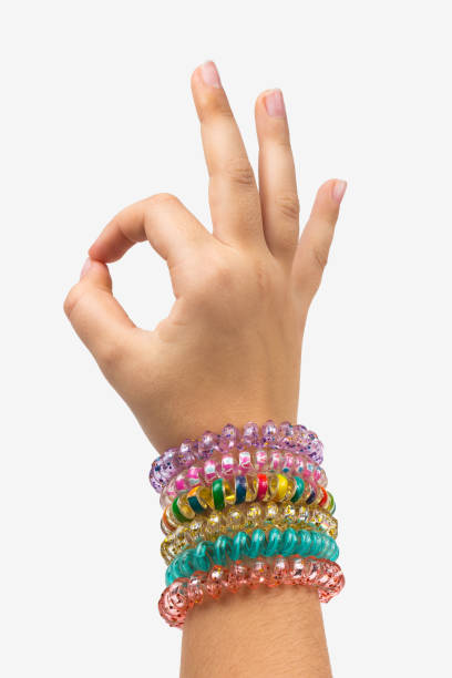 istock Child's hand with bracelets shows everything Ok edalet 937739210