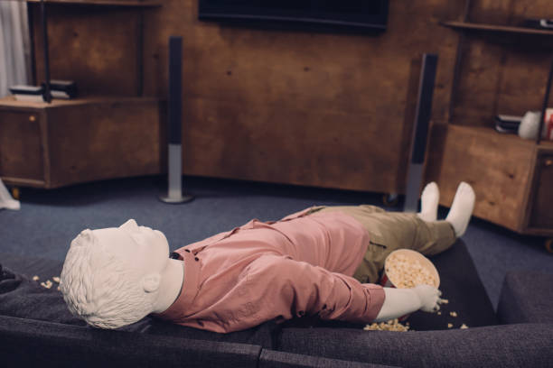 istock layman doll in casual clothes lying on sofa with popcorn 937745946