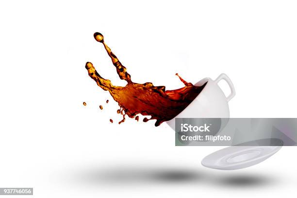 Coffee Spilling Out Of A Coffee Cup On White Background Stock Photo - Download Image Now