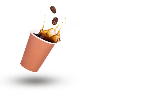 istock Coffee splash in paper cup isolated on white background 937749576