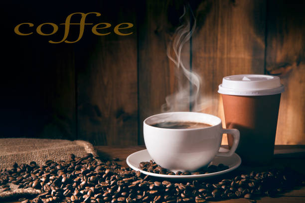 istock Cup of coffee in coffee beans on brown background 937752660