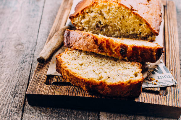 istock Homemade Sliced Banana Bread Cake on wooden backdrop on table background, top view, copy space for text 937758070