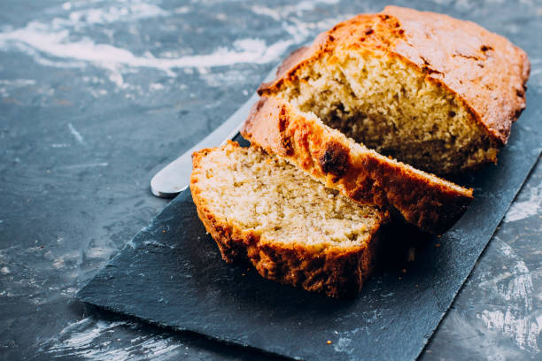 istock Homemade Sliced Banana Bread Cake on wooden backdrop on table background, top view, copy space for text 937758088