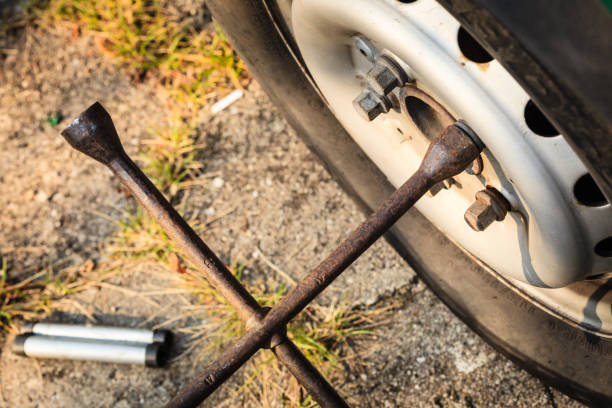 istock Fixing car tire with rim socket wrench 937764256
