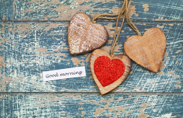istock Good morning card with three wooden hearts on rustic surface 937778218