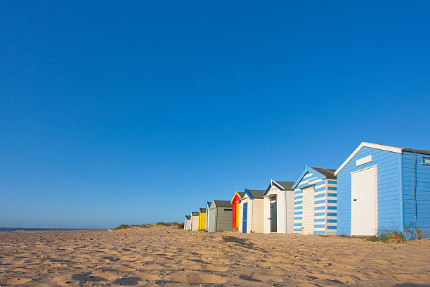 Panorama of set of southward colorful beach huts southwold beach huts by the beach at dawn beach hut photos stock pictures, royalty-free photos & images
