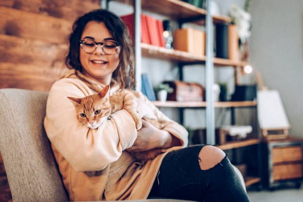 istock Young woman holding cat 937791610
