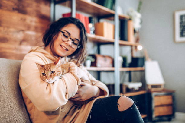 istock Young woman holding cat 937795562