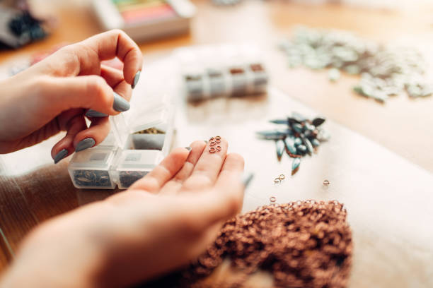 istock Female hands holds little metal rings, needlework 937797084