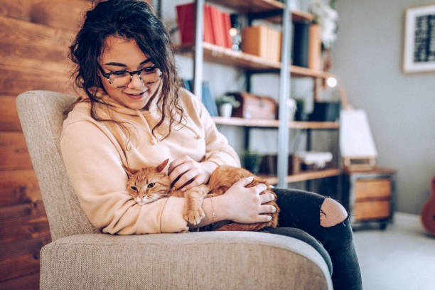 istock Young woman holding cat 937797116