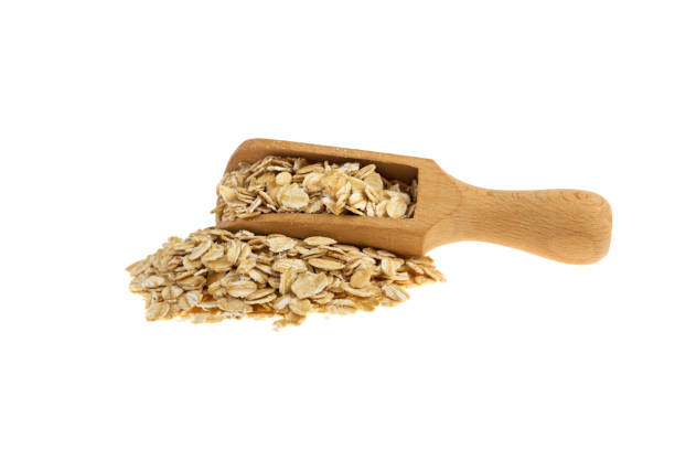 istock oatmeal on a wooden spoon isolated on a white background 937797172
