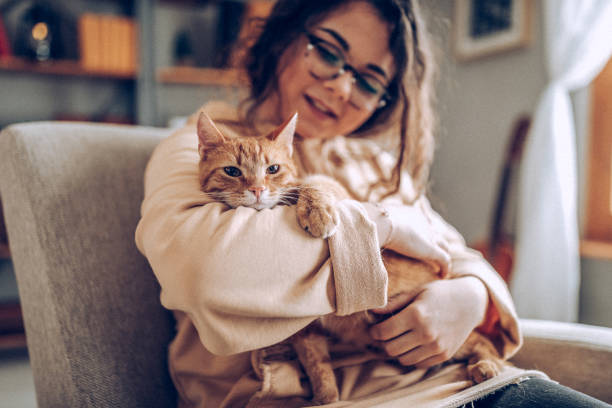 istock Young woman holding cat 937797234