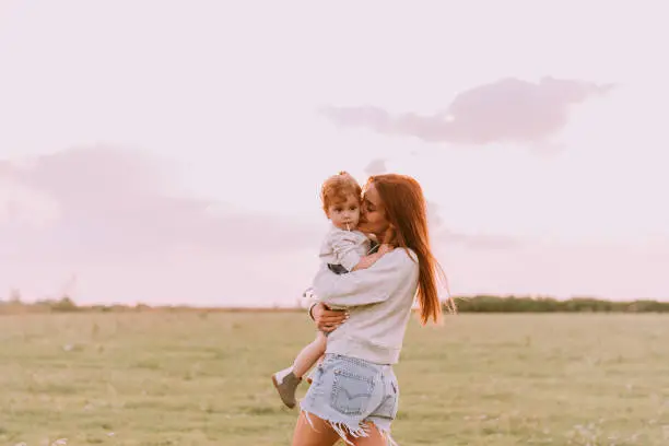 Photo of Mom playing with child outside