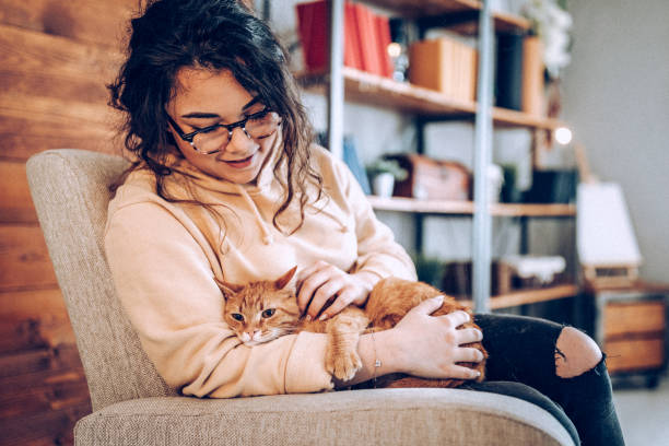 istock Young woman holding cat 937808532