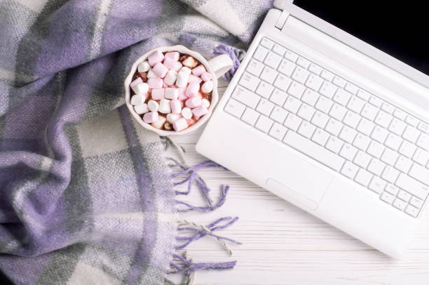 istock Coffee cup, laptop and plaid on white background. Workplace in home office top view. Concept freelance at cozy atmosphere 937808708