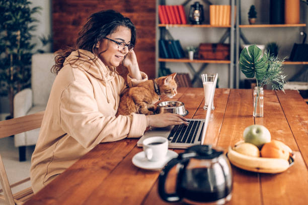 istock Enjoying working with my cat from home 937809270