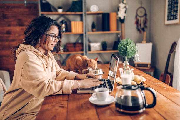 istock Enjoying working with my cat from home 937809482
