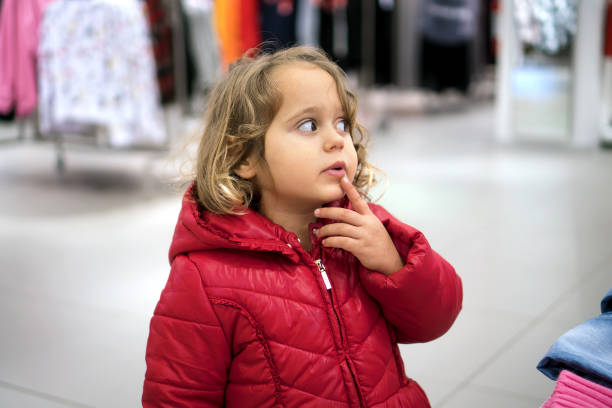Little Girl in red jacked Looking Curiously in the Store