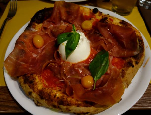 istock Italian pizza close up with bufala, mozzarella, tomatoes and basil 937810410