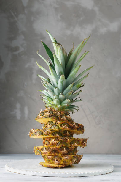 istock Fresh sliced pineapple on a wooden stand 937822386
