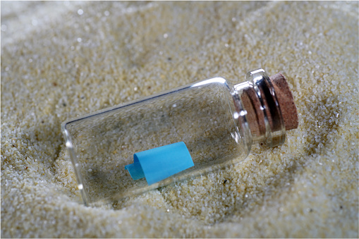 Bottle mail lying in the fine sand