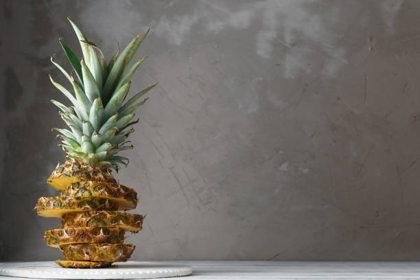 istock Fresh sliced pineapple on a wooden stand 937823092
