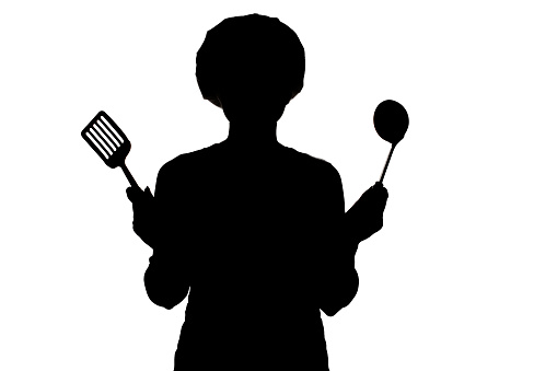 silhouette of woman cooking in a cap, profile of a girl trying to taste the soup on the salt from a spoon on a white isolated background, concept profession and homework duties of the wife