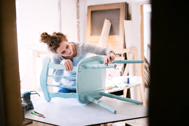 small business of a young woman. - carpenter restoring furniture wood imagens e fotografias de stock