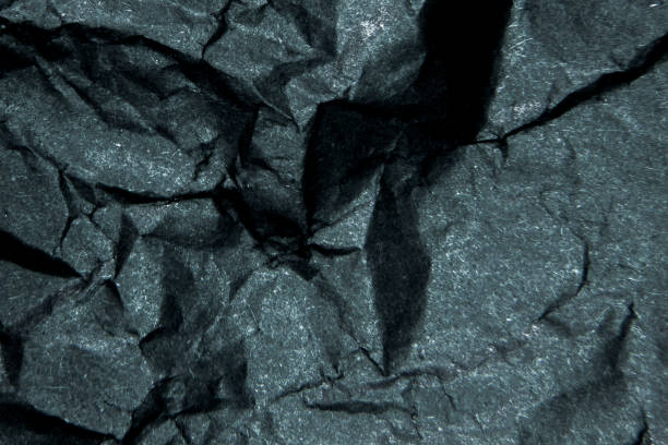 istock wrinkled black matte paper backgraund macro shot 937829324