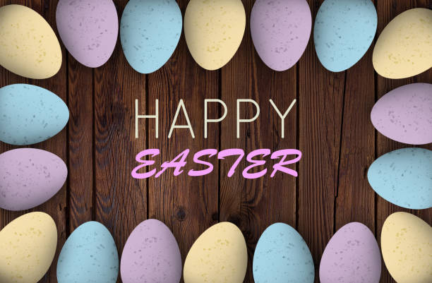 istock Pastel colored easter eggs on textured wood with a happy easter greeting 937829352