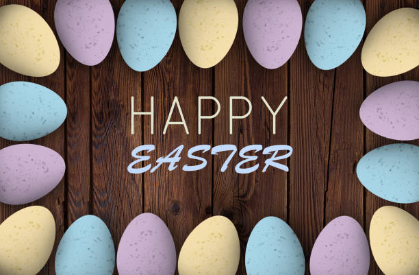istock Pastel colored easter eggs on textured wood with a happy easter greeting 937829610