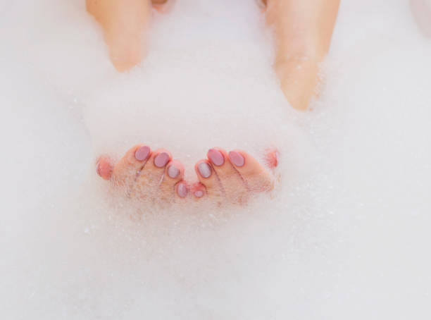 istock Beautiful female hands in white soap. Copy space, selective focus. 937829772