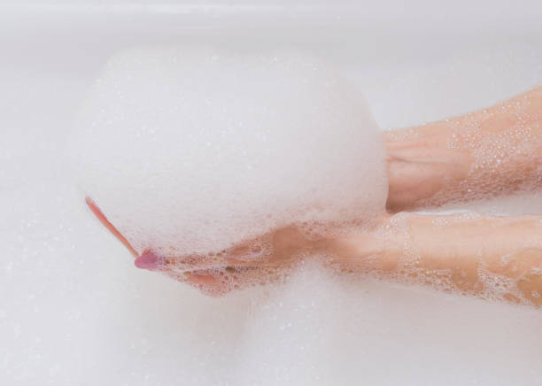 istock Beautiful female hands in white soap. Copy space, selective focus. 937829796