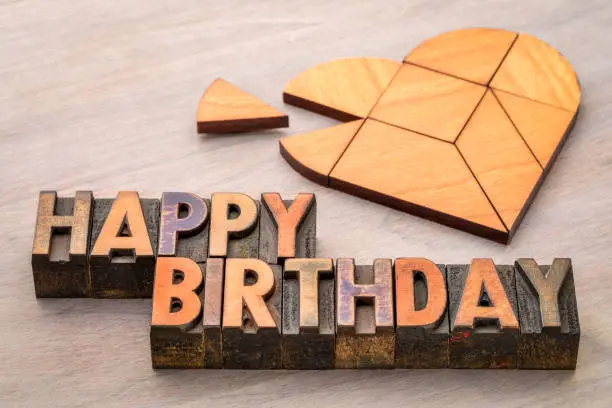 happy birthday greeting card - text in vintage letterpress wood type with a heart tangram