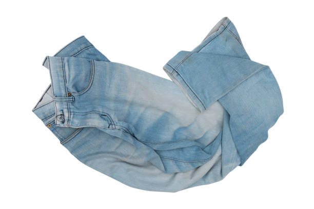 istock blue jeans in a heap isolated on white background 937836370