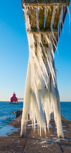 istock Sturgeon Bay North Pierhead Lighthouse looking tiny beside huge icicles 937840364