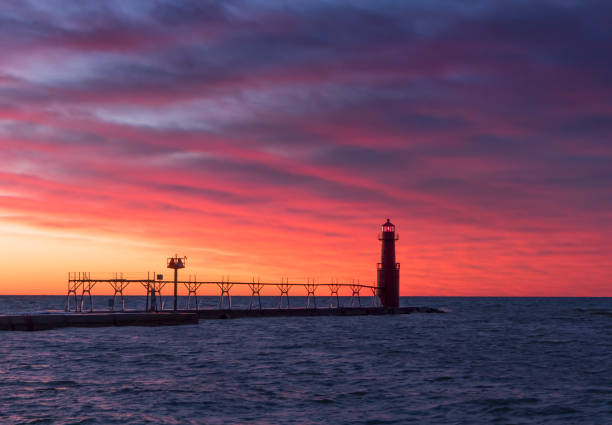 istock Algoma Wisconsin Lighthouse under fiery red twilight sky 937840450
