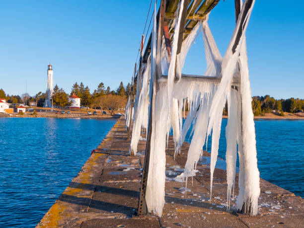 istock Sturgeon Bay Ship Canal Lighthouse dwarfed by huge icicles 937840486